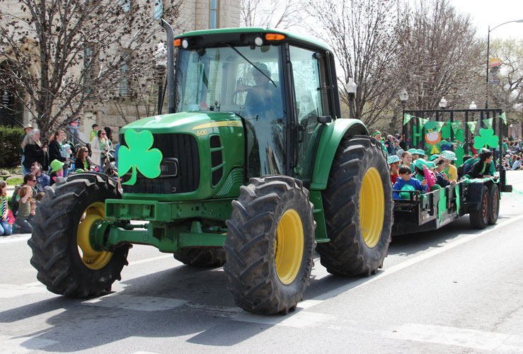 Photo of a decorated green tracktor in the parade on Massachusetts Street.
